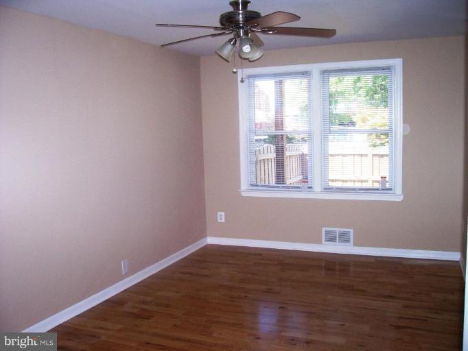 2462 Nevada Street Baltimore, MD 21230 - Photo 5 of 22 a view of an empty room with wooden floor and a window