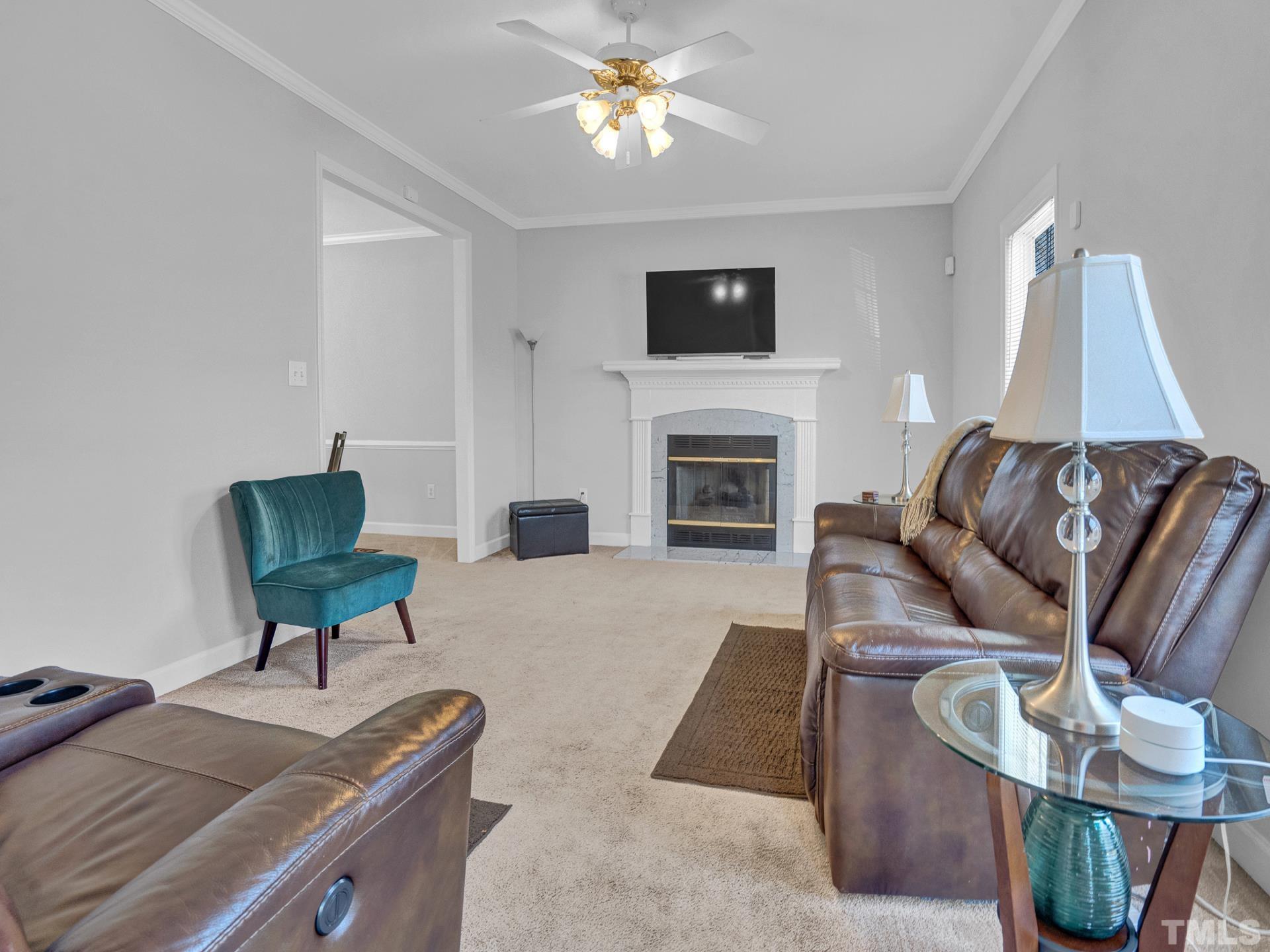 4305 Gallatree Lane Raleigh, NC 27616 - Photo 2 of 21 a living room with furniture and a fireplace