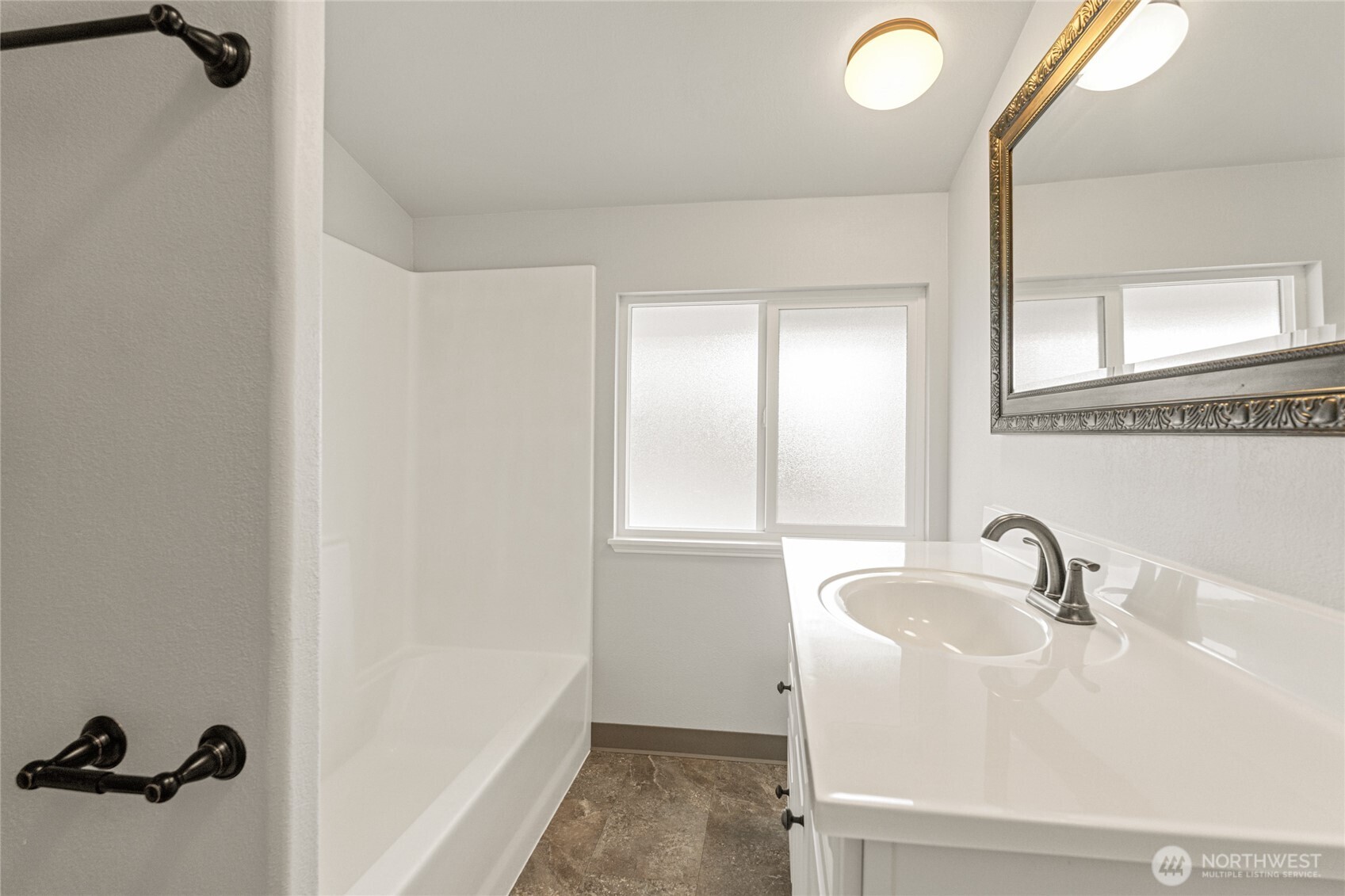 314 West 3rd Street Omak, WA 98841 - Photo 18 of 28 a bathroom with a sink and a mirror