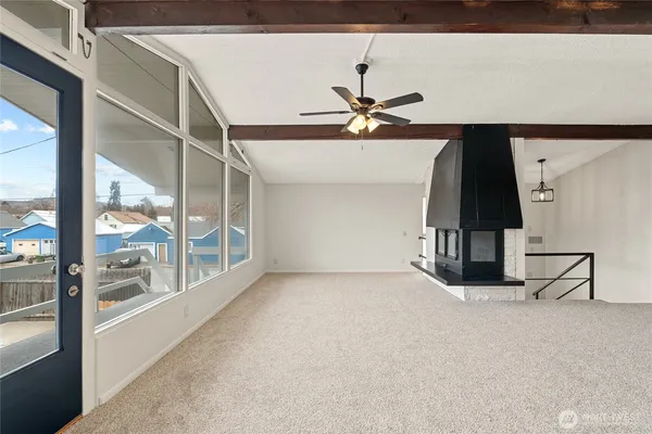 a view of a livingroom with a ceiling fan and window