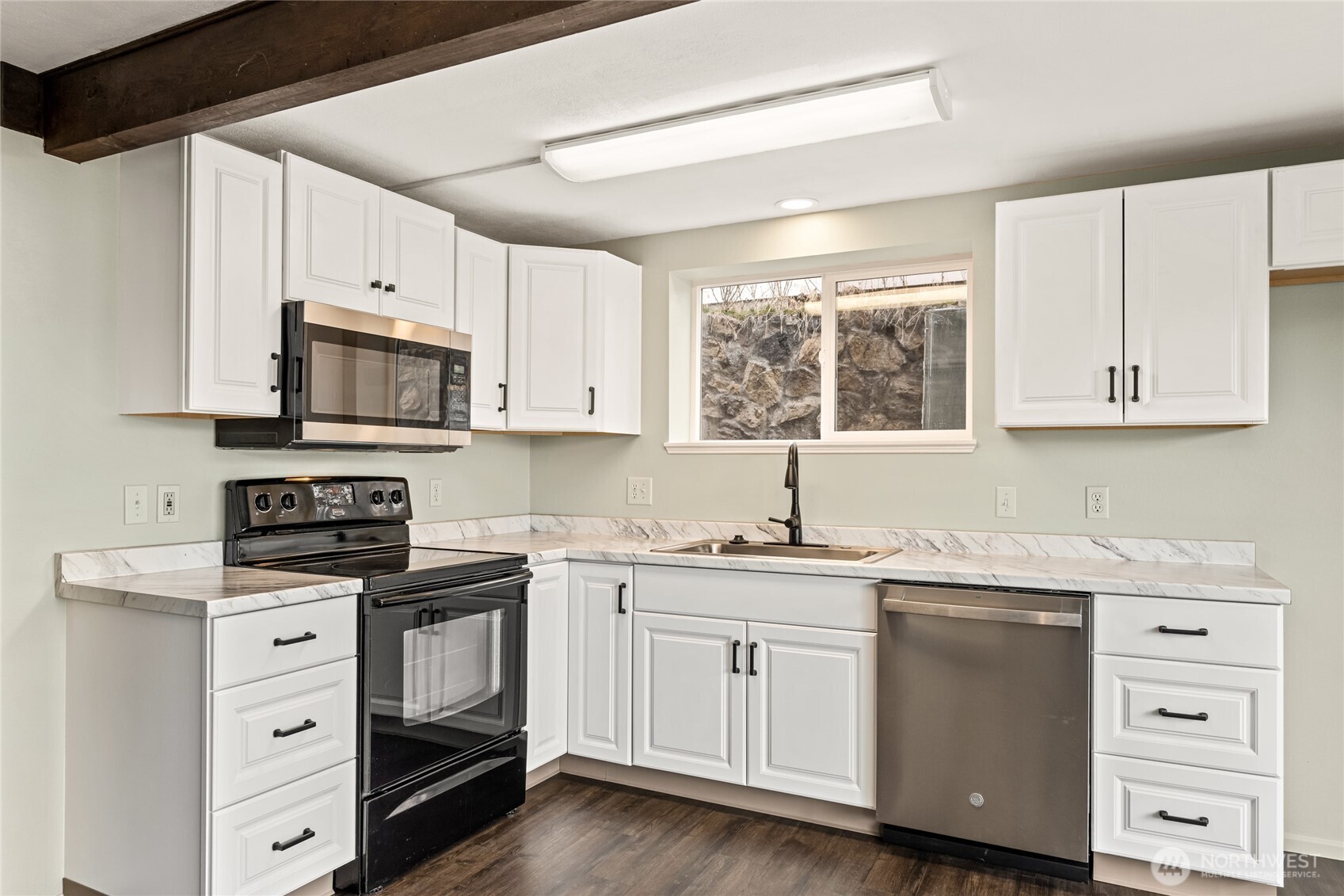314 West 3rd Street Omak, WA 98841 - Photo 8 of 28 a kitchen with cabinets appliances a sink and a window
