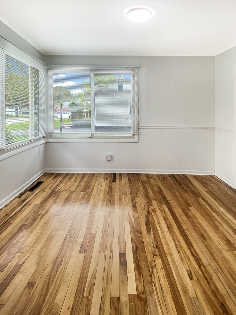 Undisclosed Address Round Lake Beach, IL 60073 - Photo 3 of 10 a view of empty room with wooden floor and fan