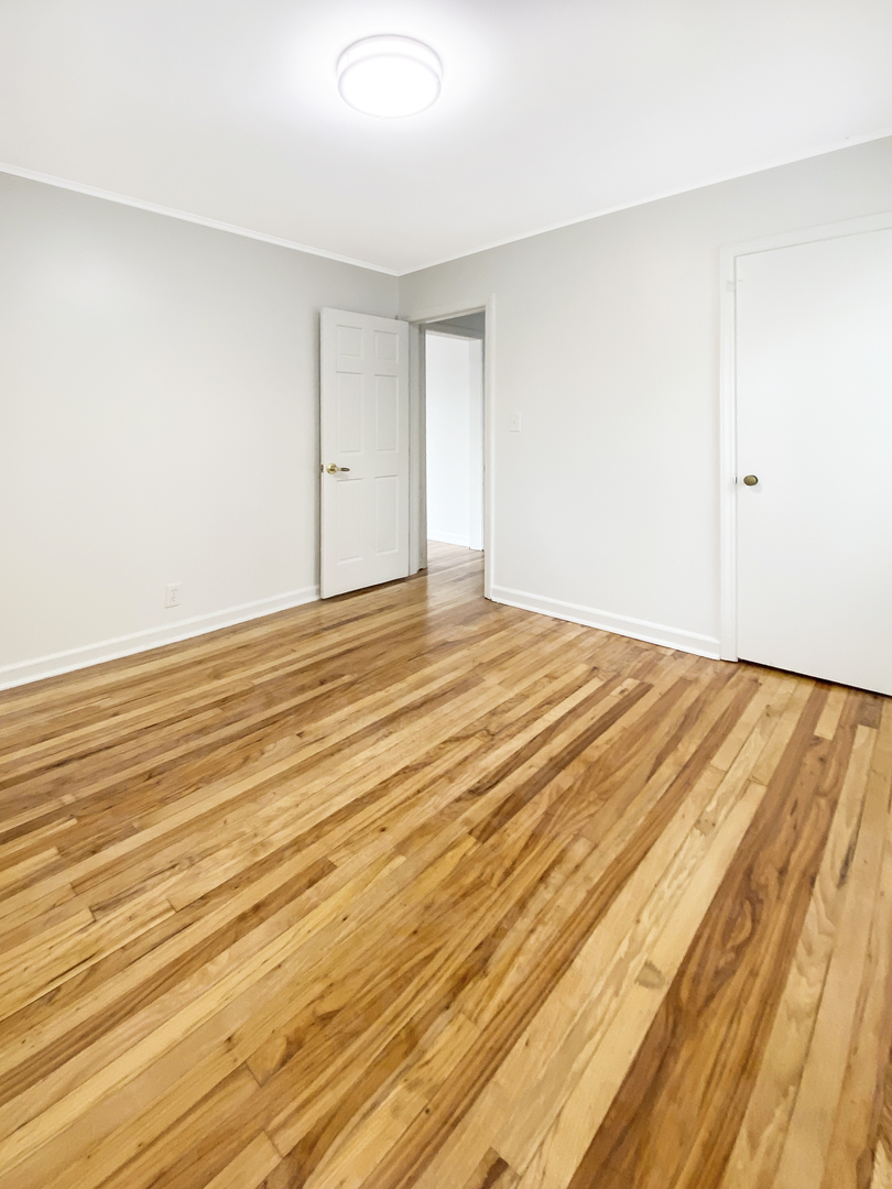 Undisclosed Address Round Lake Beach, IL 60073 - Photo 5 of 10 a view of an empty room with wooden floor
