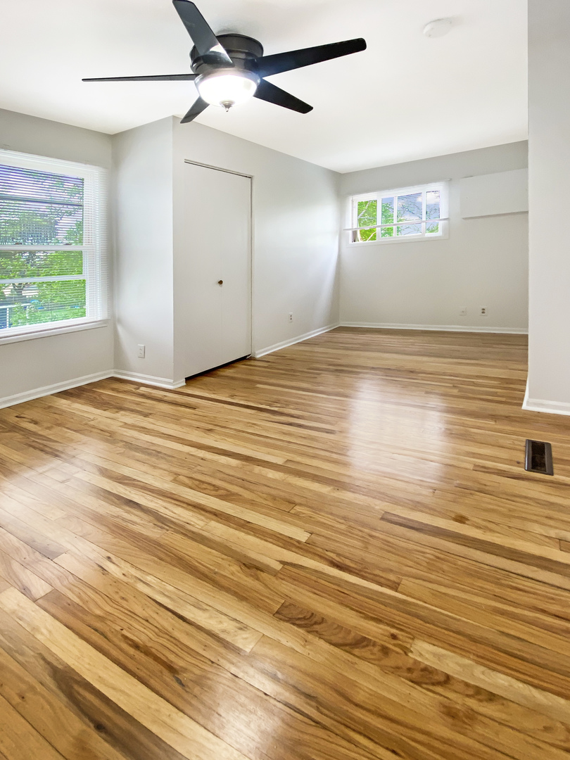 Undisclosed Address Round Lake Beach, IL 60073 - Photo 6 of 10 an empty room with wooden floor and windows