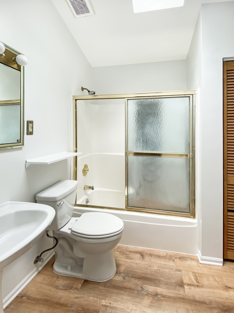 Undisclosed Address Round Lake Beach, IL 60073 - Photo 9 of 10 a bathroom with a toilet a sink and a window