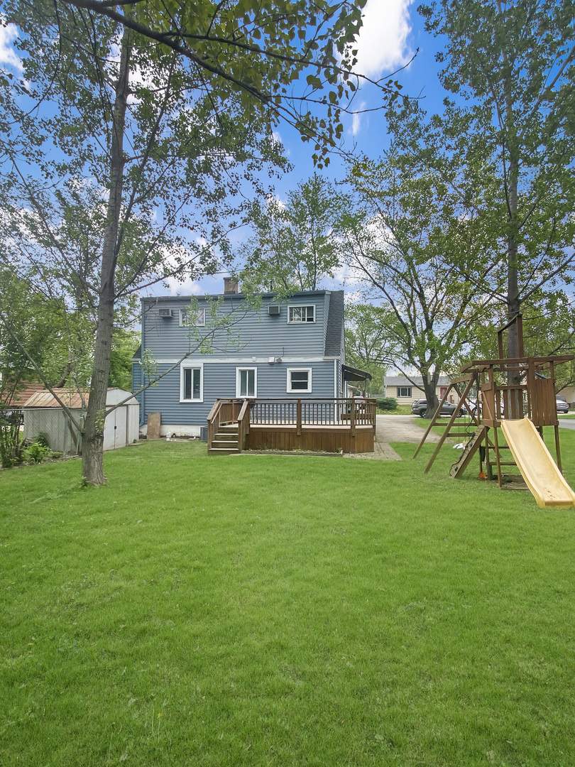 Undisclosed Address Round Lake Beach, IL 60073 - Photo 10 of 10 a front view of house with a garden and trees