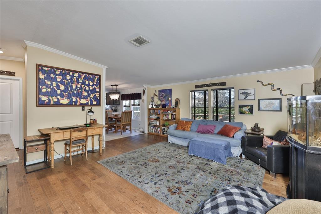 20112 Hobbs Road Wimauma, FL 33598 - Photo 21 of 94 a living room with furniture and a wooden floor