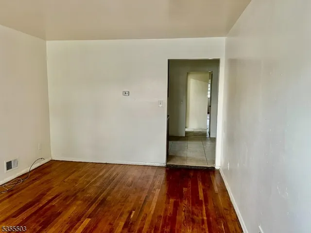 a view of a room with wooden floor