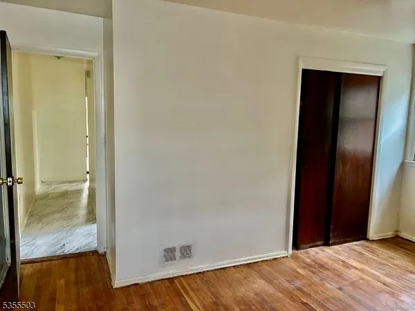 a kitchen with a refrigerator a stove top oven and cabinets