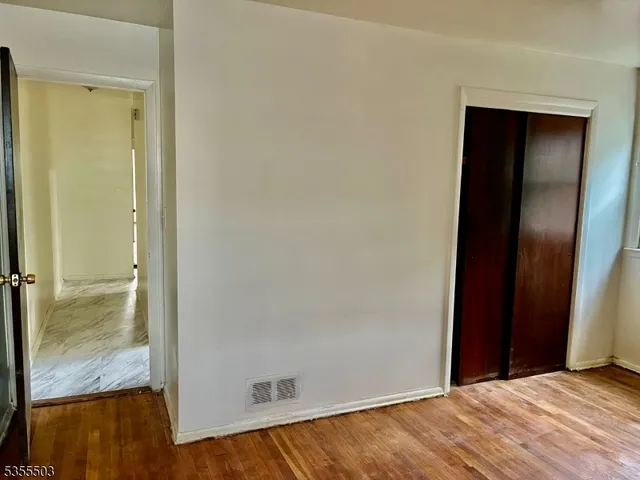 a kitchen with a refrigerator a stove top oven and cabinets