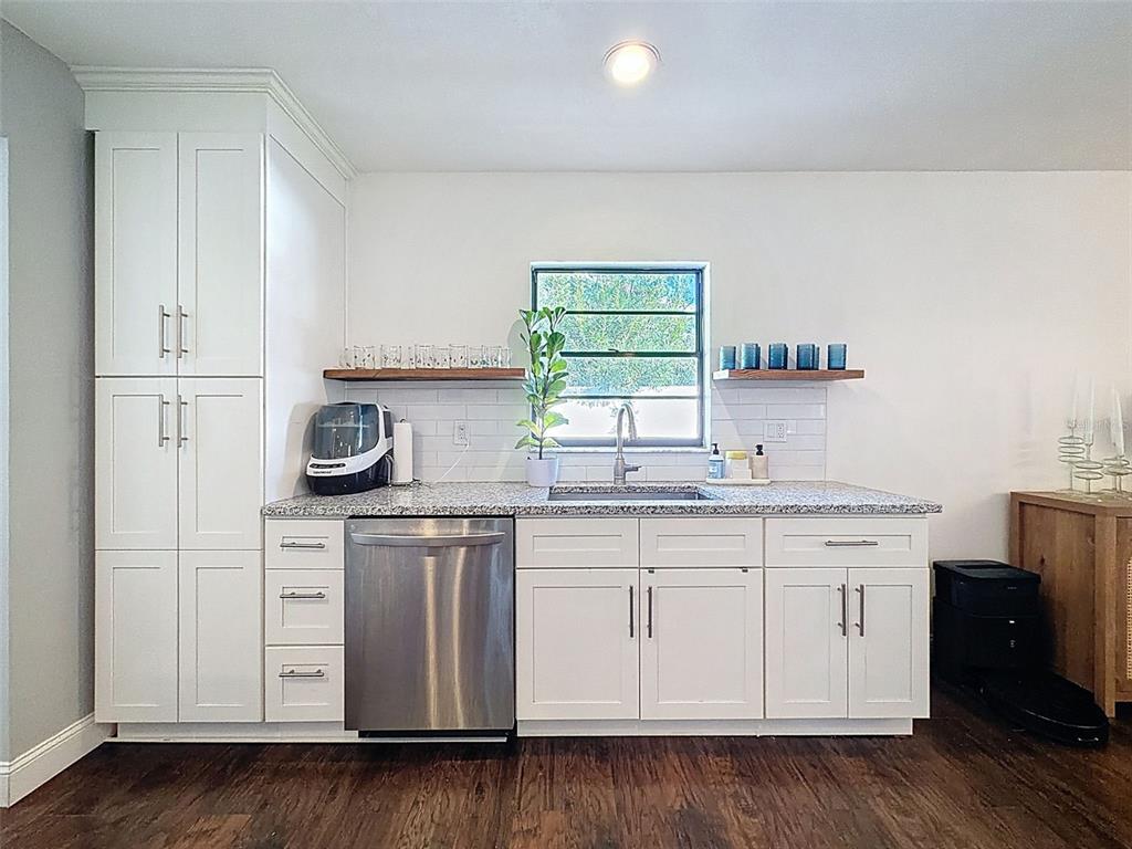 7813 River Ridge Drive Temple Terrace, FL 33637 - Photo 15 of 43 a kitchen with stainless steel appliances white cabinets and a sink