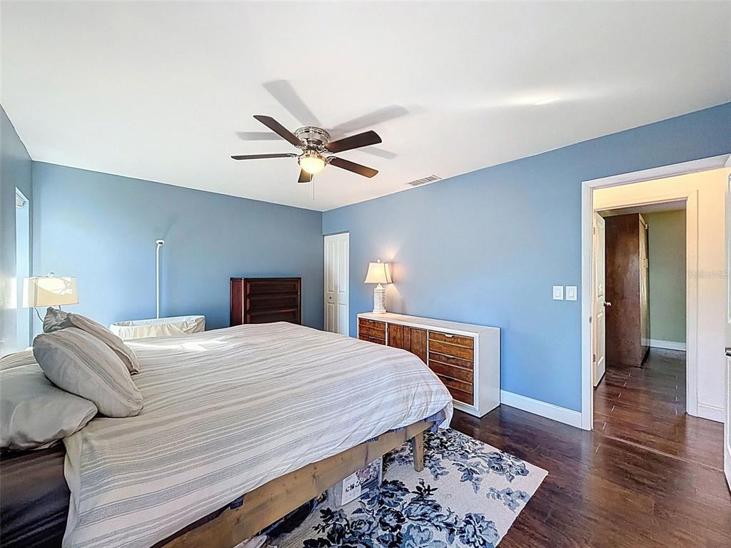 7813 River Ridge Drive Temple Terrace, FL 33637 - Photo 20 of 43 a bedroom with a bed and wooden floor