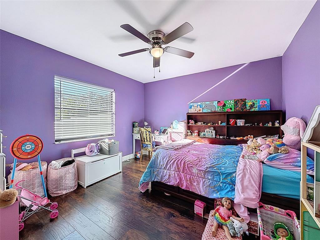 7813 River Ridge Drive Temple Terrace, FL 33637 - Photo 26 of 43 a bedroom with a bed and a chandelier