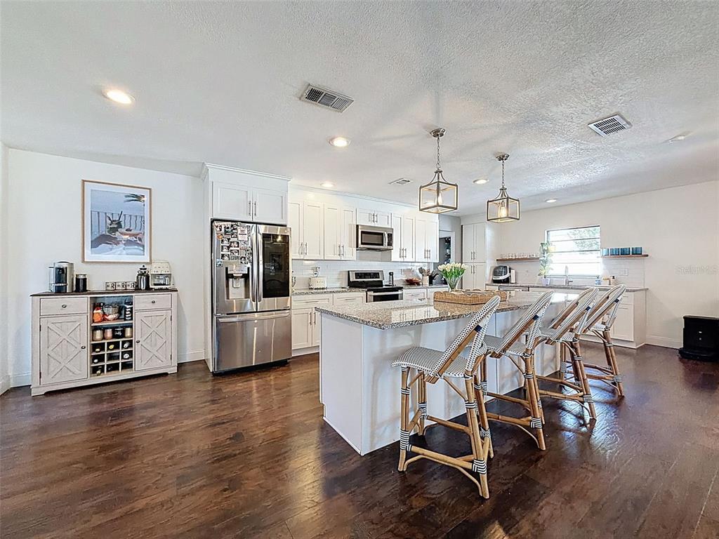 7813 River Ridge Drive Temple Terrace, FL 33637 - Photo 3 of 43 a kitchen with stainless steel appliances kitchen island granite countertop a refrigerator and cabinets