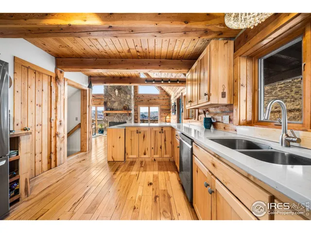 a open kitchen with stainless steel appliances kitchen island granite countertop a wooden cabinets