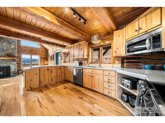 a kitchen with stainless steel appliances kitchen island granite countertop a refrigerator a sink and dishwasher