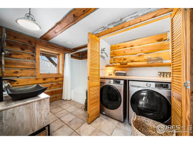 a backyard of a house with barbeque oven table and chairs