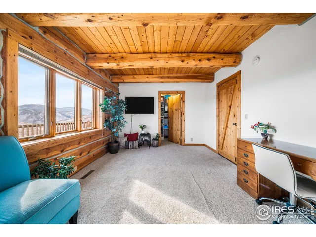 a living room with furniture a rug and a floor to ceiling window
