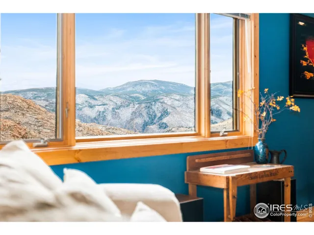a living room with furniture and paintings on the wall