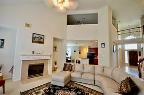 a view of a hallway with wooden floor and a flat screen tv