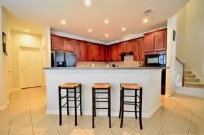 a kitchen with stainless steel appliances a stove a microwave and a sink