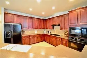 a kitchen with wooden cabinets and a stove top oven