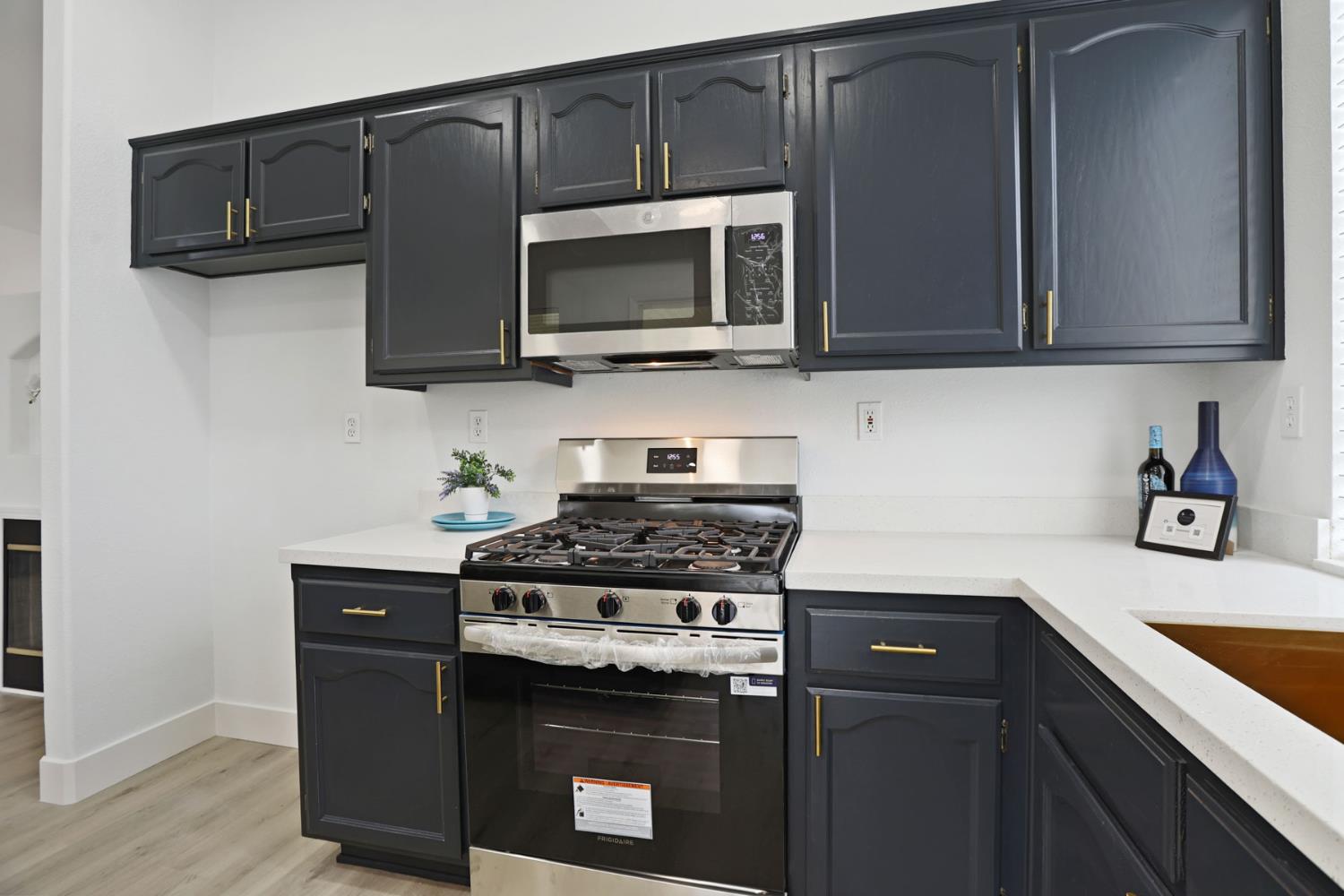 1829 Nighthawk Circle Roseville, CA 95661 - Photo 13 of 34 a kitchen with stainless steel appliances granite countertop a stove and a microwave