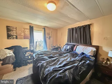 a bed sitting in a bedroom next to a window