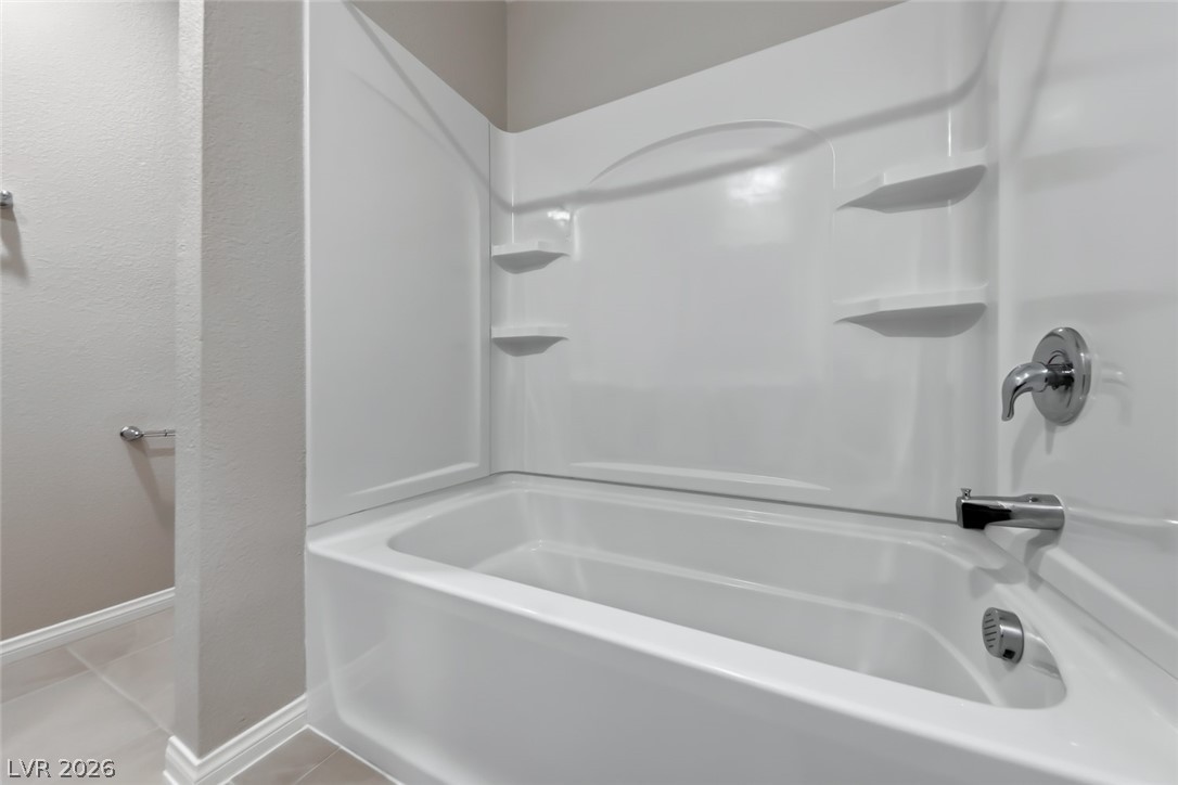 3564 Credere Lane Henderson, NV 89074 - Photo 32 of 40 Bathroom with shower combination, light tile patterned floors, and a textured wall