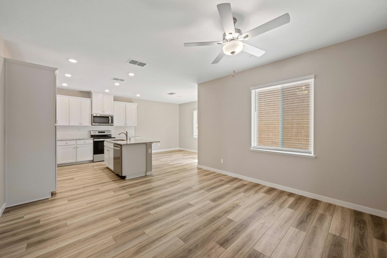 2979 Bowery Lane Lincoln, CA 95648 - Photo 3 of 19 a view of kitchen with kitchen island stainless steel appliances sink cabinets and wooden floor