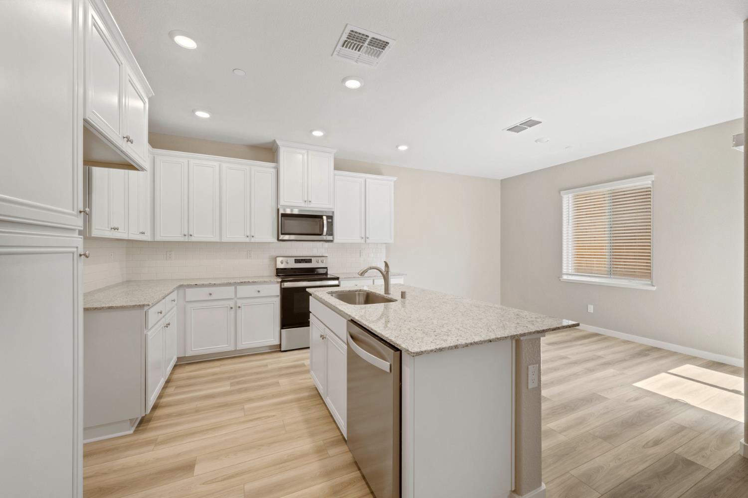 2979 Bowery Lane Lincoln, CA 95648 - Photo 5 of 19 a kitchen with a sink stove and cabinets