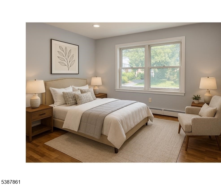 85 Grove Street South Hackensack, NJ 07606 - Photo 15 of 32 a bedroom with a bed and wooden floor