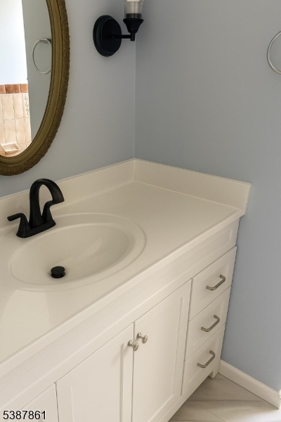 85 Grove Street South Hackensack, NJ 07606 - Photo 16 of 32 a bathroom with a sink and mirror