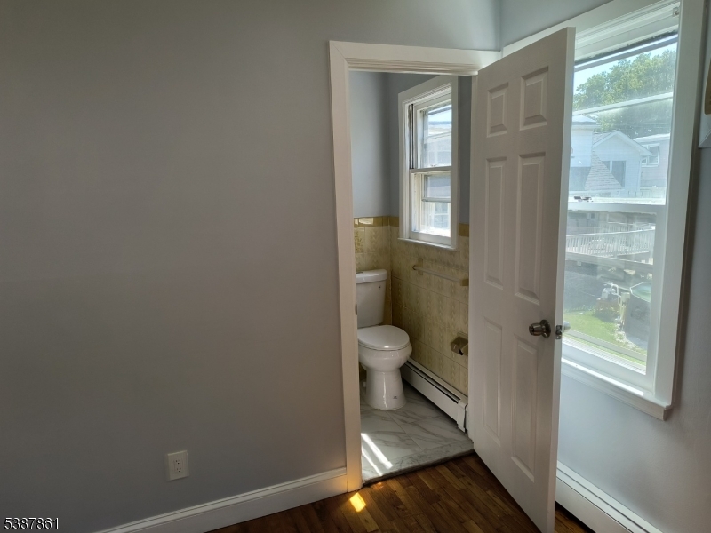 85 Grove Street South Hackensack, NJ 07606 - Photo 17 of 32 a bathroom with a toilet and a shower