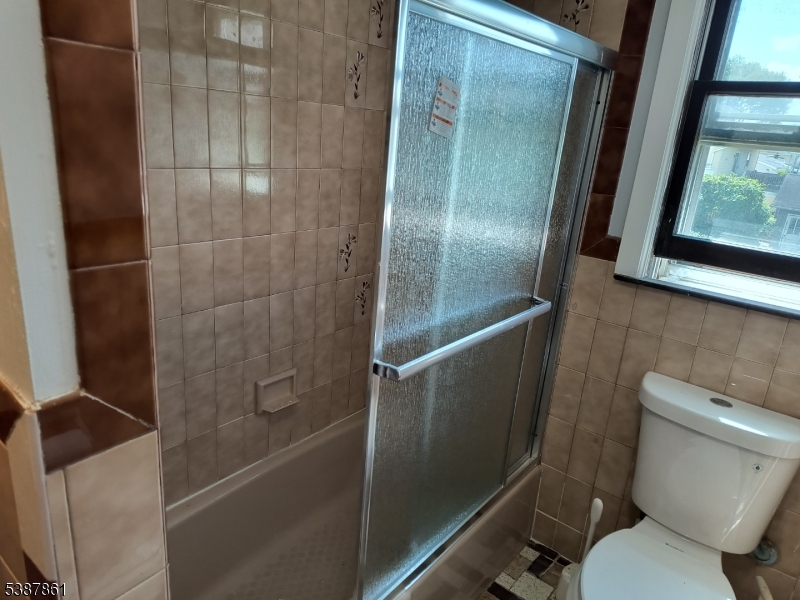 85 Grove Street South Hackensack, NJ 07606 - Photo 19 of 32 a bathroom with a toilet and a shower