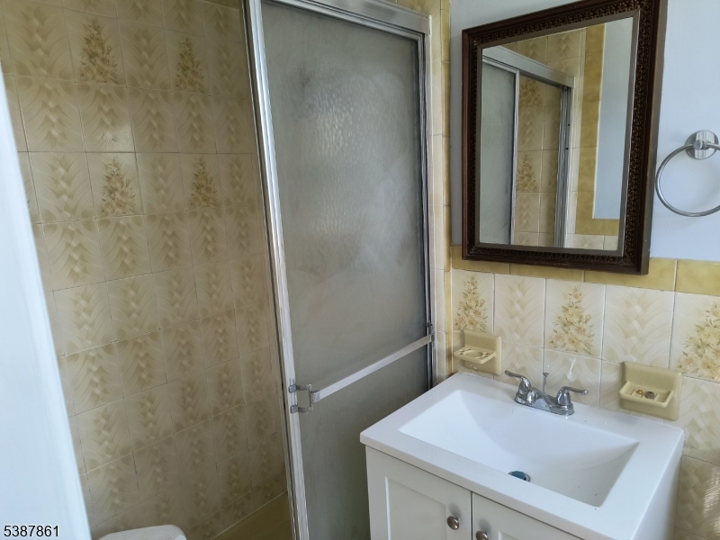 85 Grove Street South Hackensack, NJ 07606 - Photo 20 of 32 a bathroom with a sink and a mirror