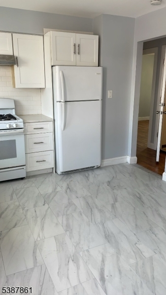 85 Grove Street South Hackensack, NJ 07606 - Photo 23 of 32 a white refrigerator freezer and a stove sitting inside of a kitchen