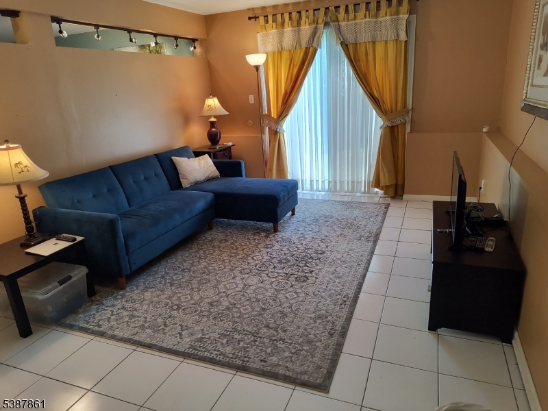 85 Grove Street South Hackensack, NJ 07606 - Photo 27 of 32 a living room with furniture and a rug