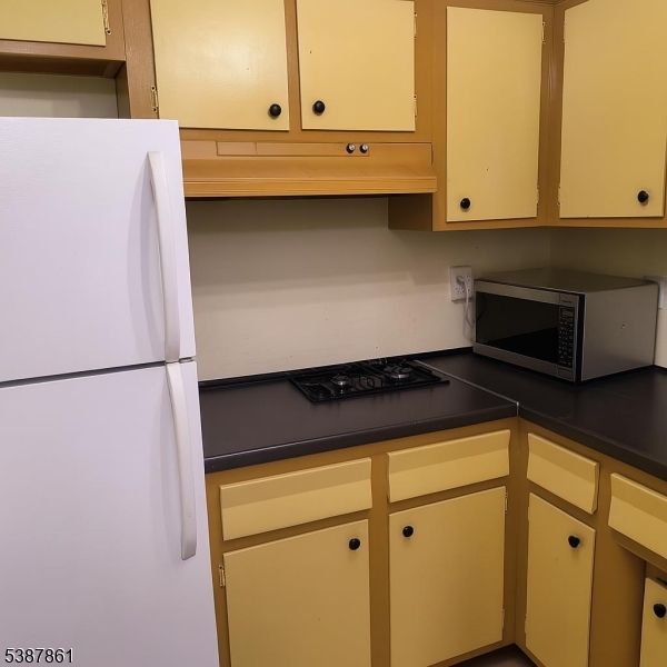 85 Grove Street South Hackensack, NJ 07606 - Photo 29 of 32 a view of a refrigerator with white cabinets