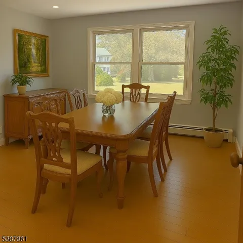a view of a dining room with furniture and a window