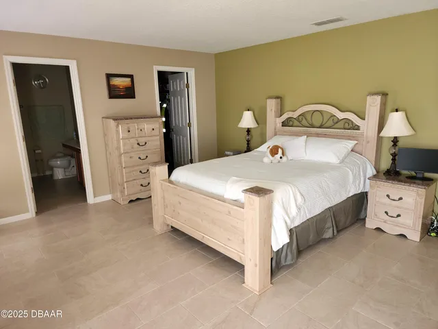 a bedroom with a bed and a television