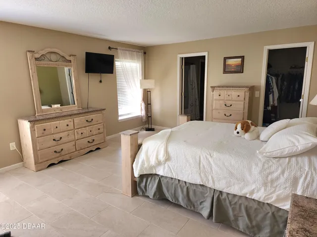 a bedroom with a bed and a television