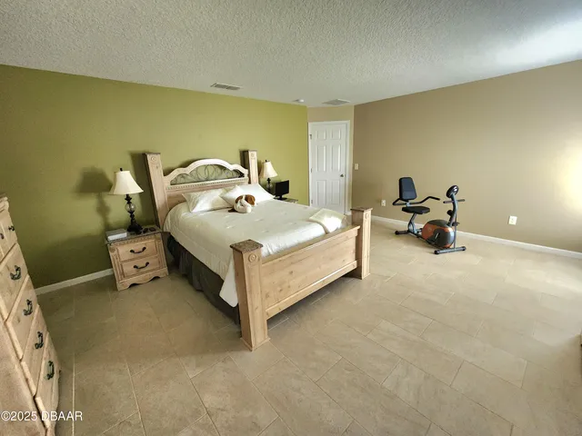 a bed room with a bed and a chair