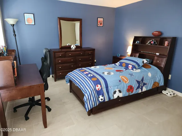 a bedroom with a bed and a desk