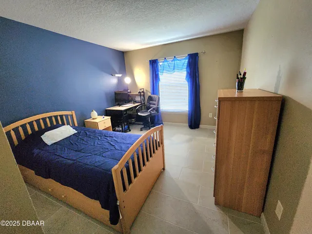 a bedroom with furniture and wooden floor