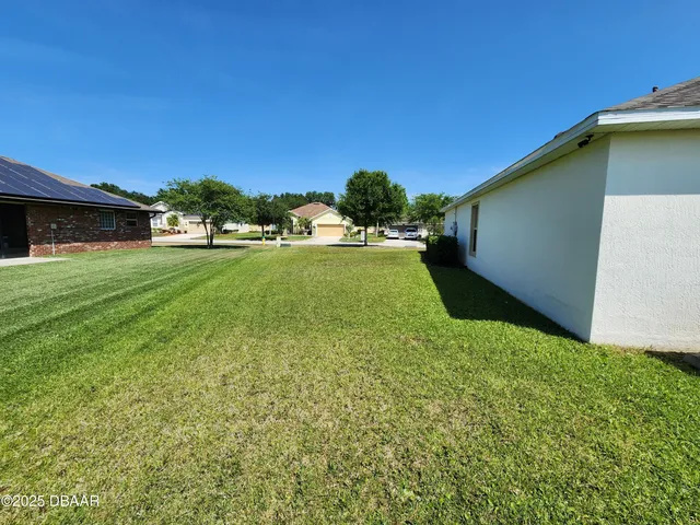 a backyard of a house with lots of green space