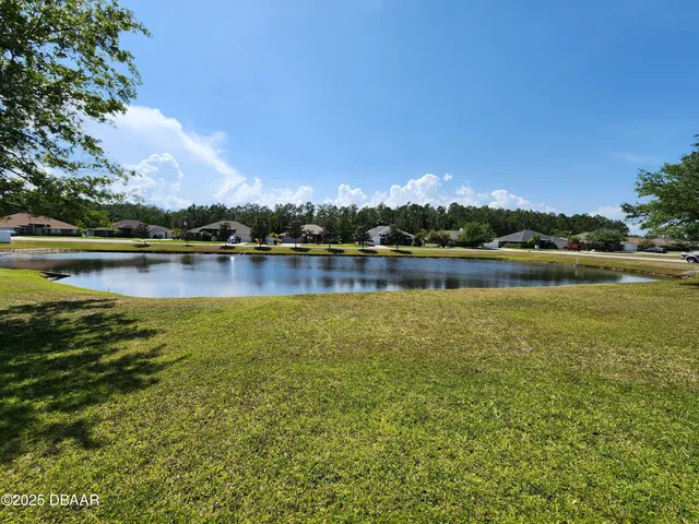 a view of a lake with houses in the back