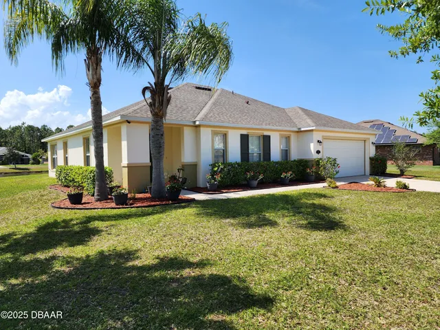 a front view of house with yard and outdoor seating