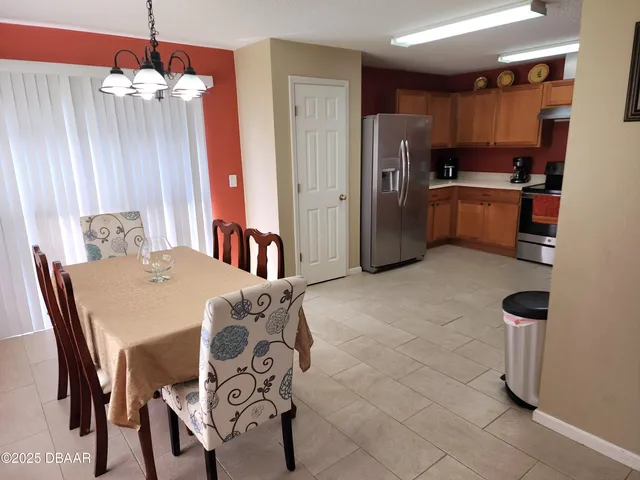 a kitchen with stainless steel appliances kitchen island granite countertop a refrigerator and a stove top oven