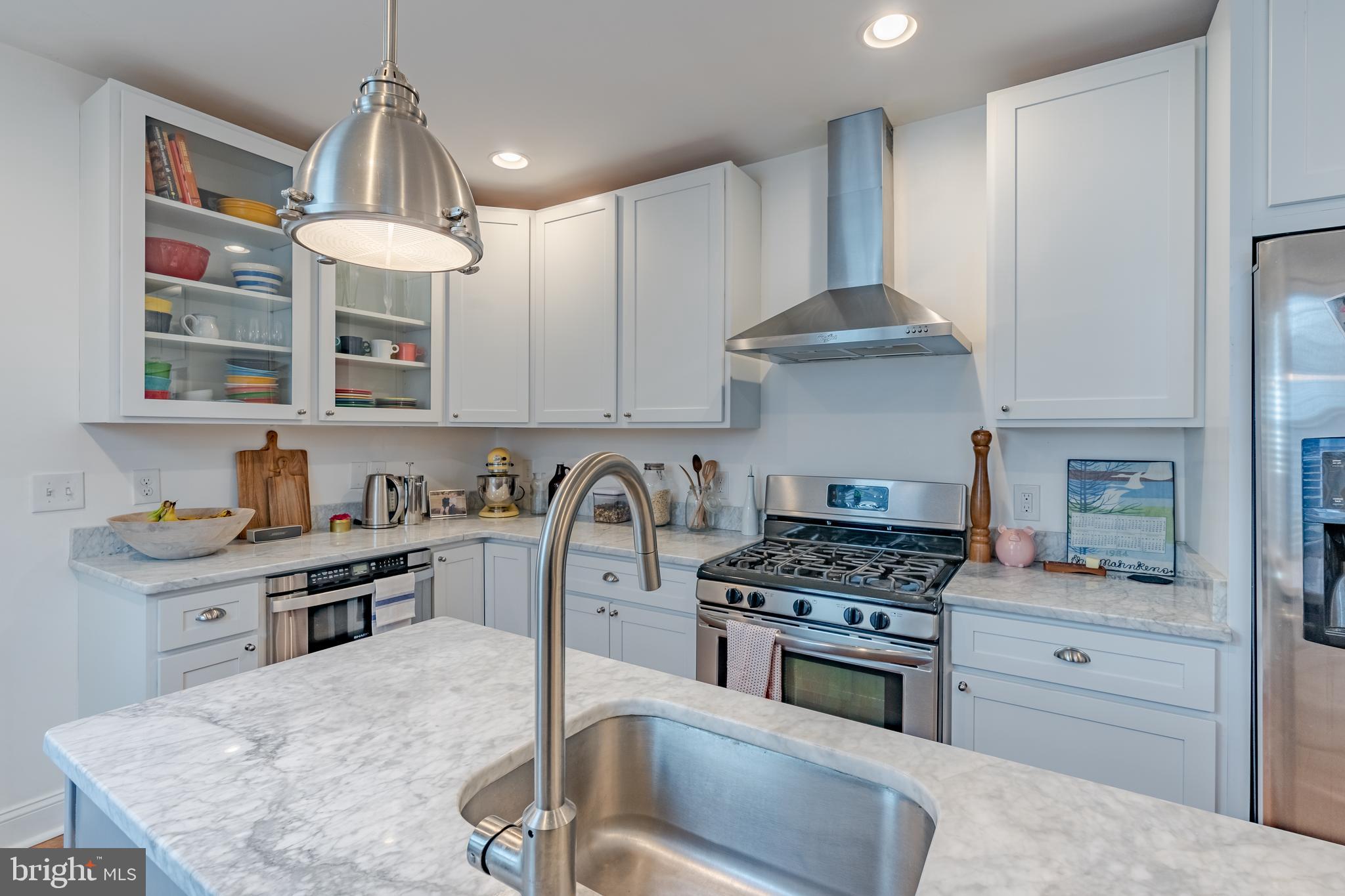 a kitchen with granite countertop a stove a sink and a cabinets